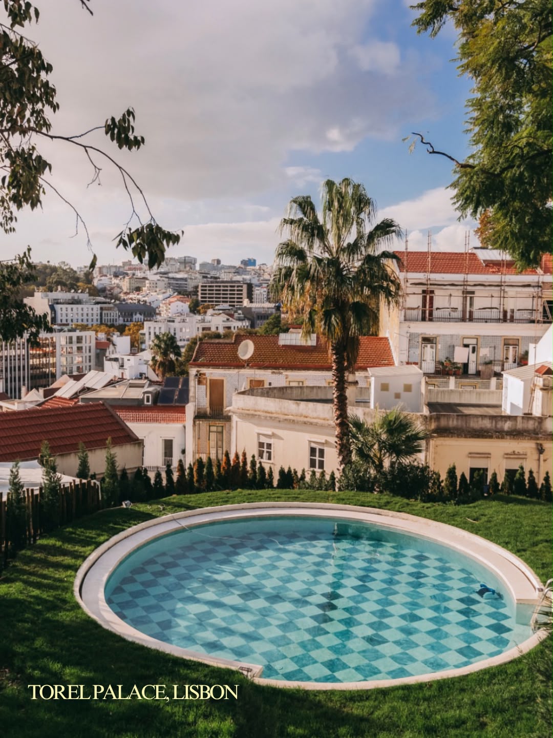 The tiled circular pool at Torel Palace overlooking Lisbon's rooftops