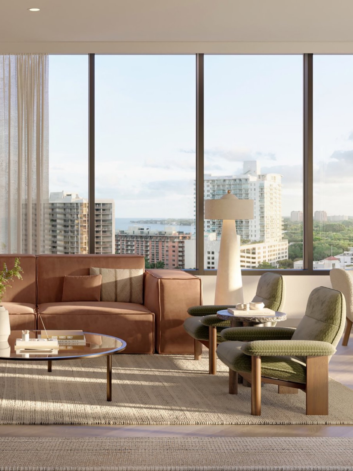 A residential living room in warm neutrals with floor-to-ceiling glass over Coconut Grove