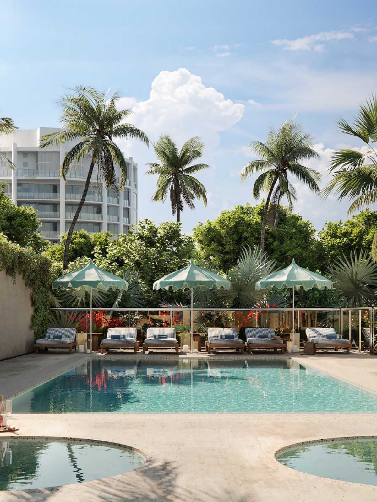 A palm-shaded pool deck with striped loungers and green parasols